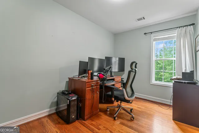 a view of workspace with wooden floor windows
