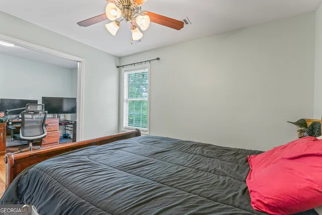 a bedroom with a bed and a chandelier