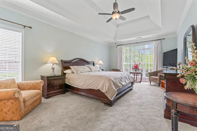 a bedroom with a bed flat screen tv and a couch