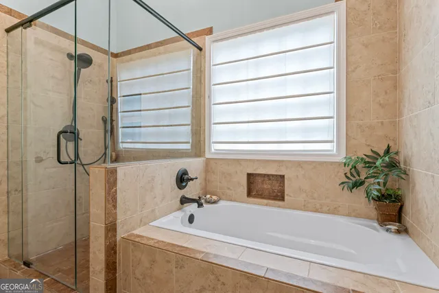 a bathroom with a tub and shower