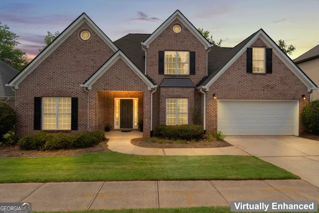 a front view of a house with a yard