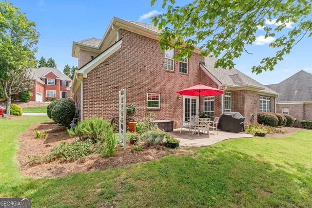 a view of a house with backyard sitting area and garden