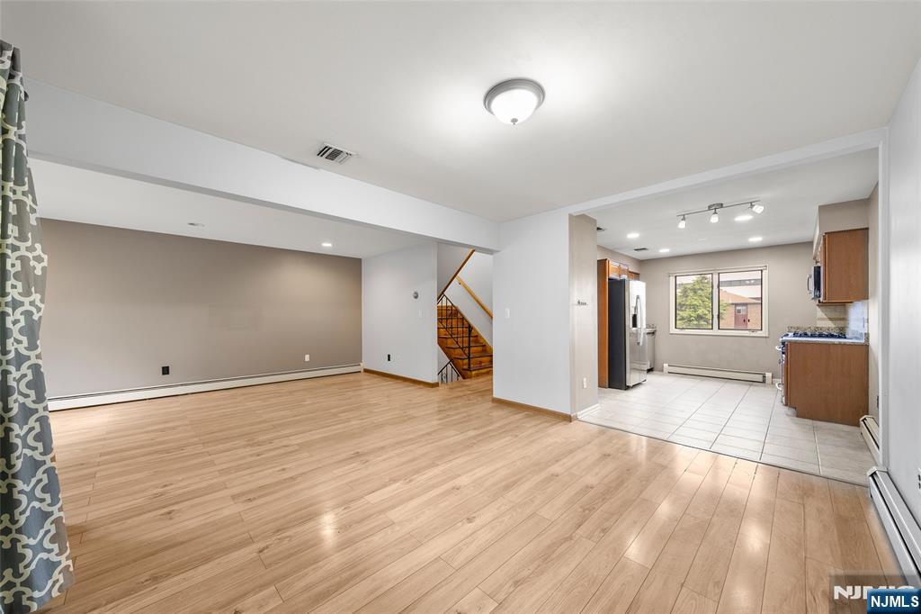 140 Allwood Road, Unit C Clifton, NJ 07012 - Photo 12 of 31 a view of empty room with wooden floor and windows