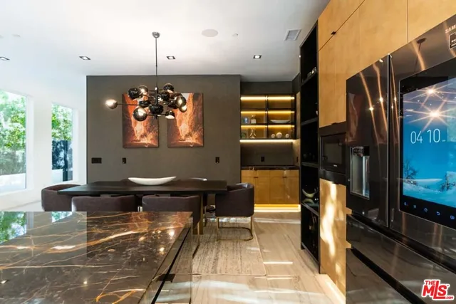 a living room with furniture a desk and large window