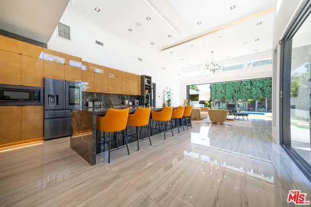 a living room with lots of furniture and a large window