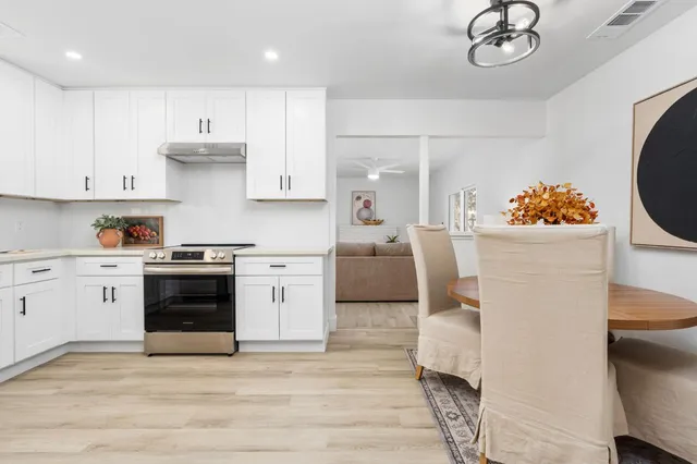 a kitchen with a white stove top oven and refrigerator