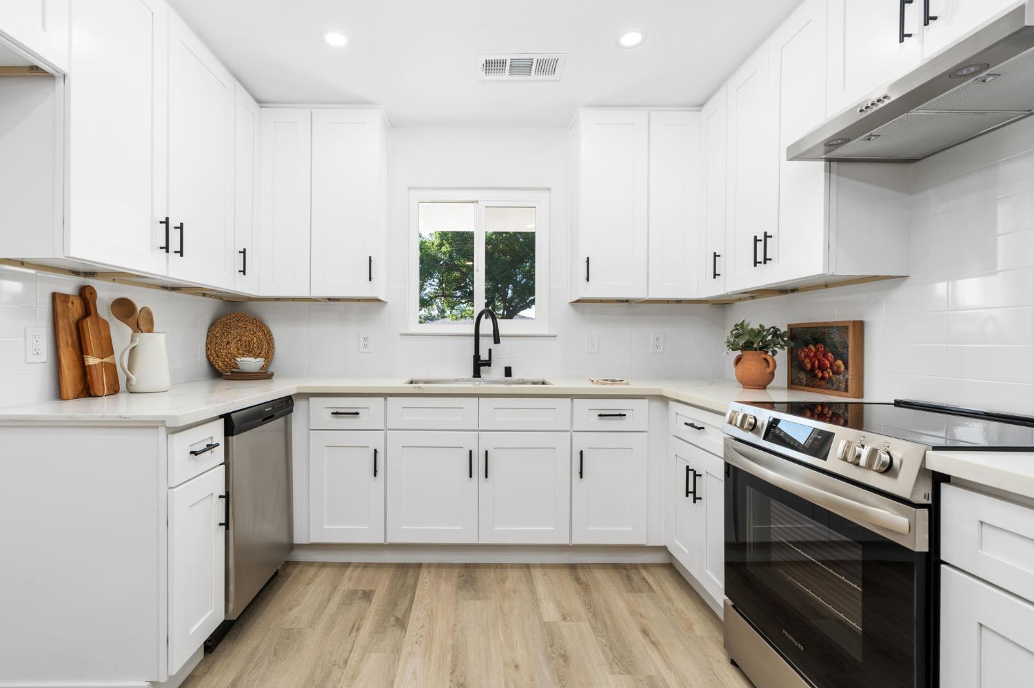 801 West Santa Ana Avenue Clovis, CA 93612 - Photo 13 of 32 a kitchen with white cabinets appliances and a sink