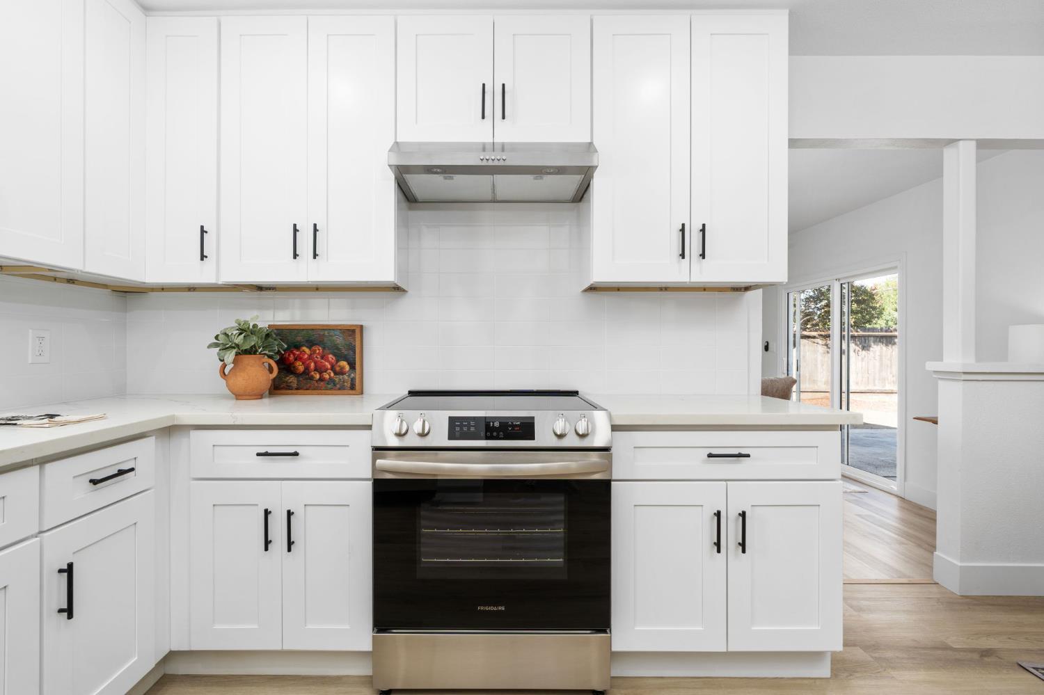 801 West Santa Ana Avenue Clovis, CA 93612 - Photo 15 of 32 a kitchen with white cabinets and white appliances