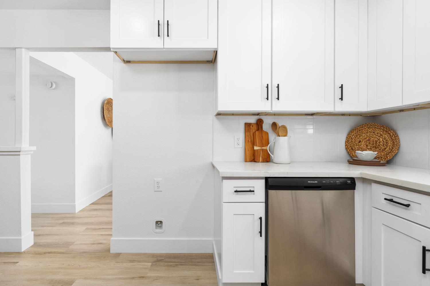 801 West Santa Ana Avenue Clovis, CA 93612 - Photo 16 of 32 a kitchen with granite countertop white cabinets and wooden floor