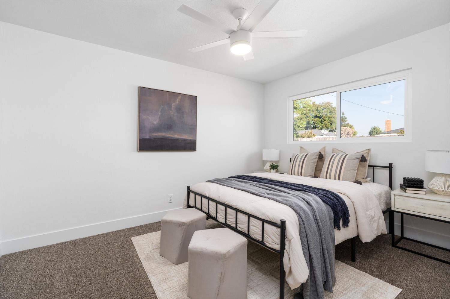 801 West Santa Ana Avenue Clovis, CA 93612 - Photo 23 of 32 a bedroom with a bed and a chandelier