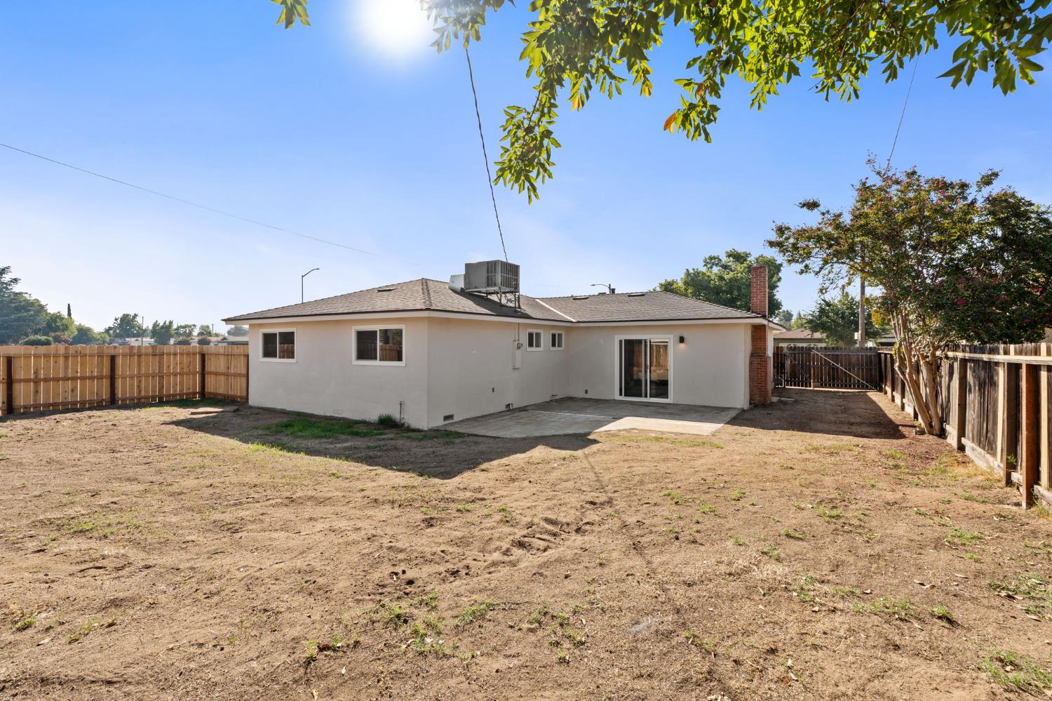 801 West Santa Ana Avenue Clovis, CA 93612 - Photo 27 of 32 a backyard of a house with a yard and garage