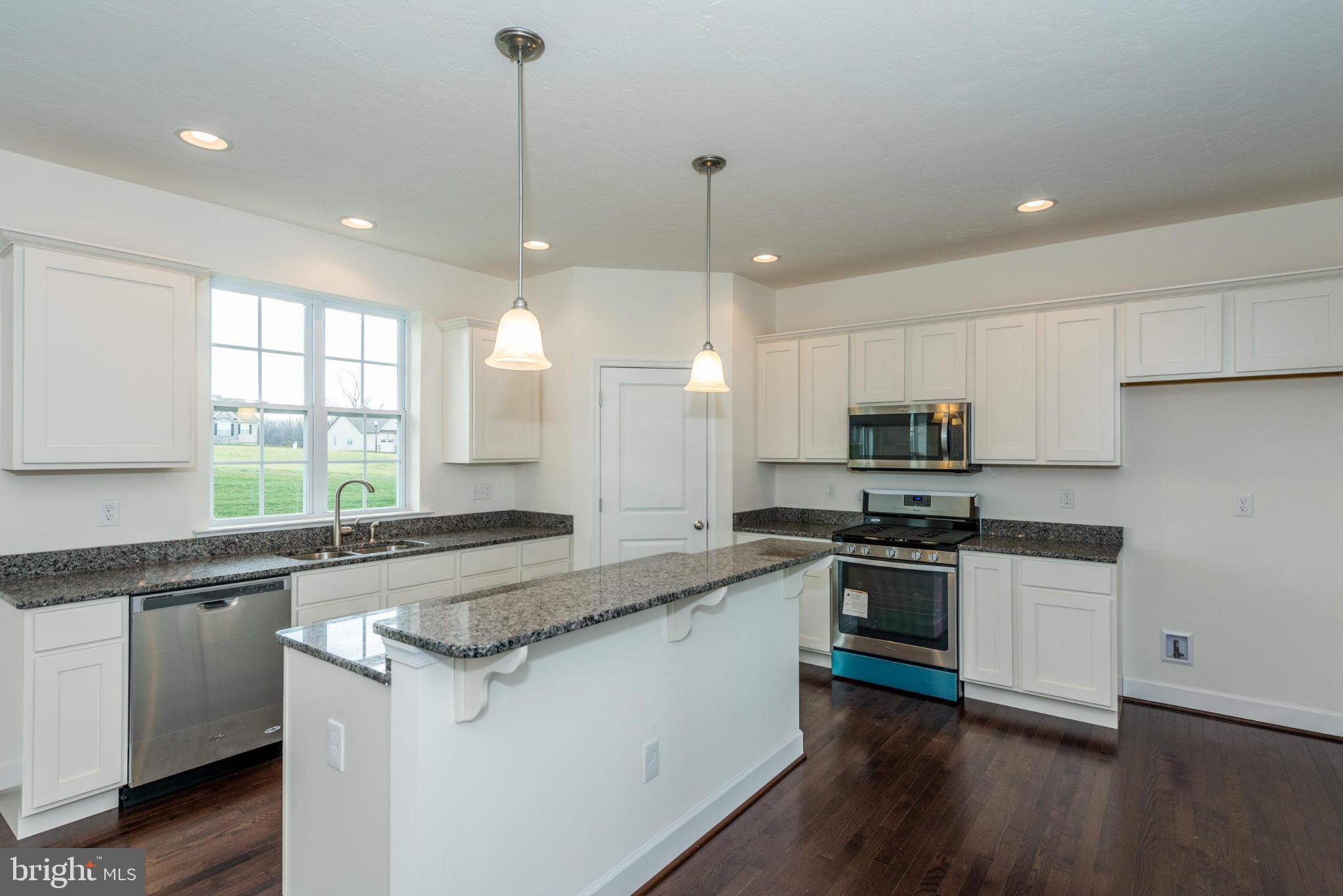 1194 Bair Road, Unit 39 Hanover, PA 17331 - Photo 11 of 12 a kitchen with stainless steel appliances granite countertop a sink a stove and a wooden floors