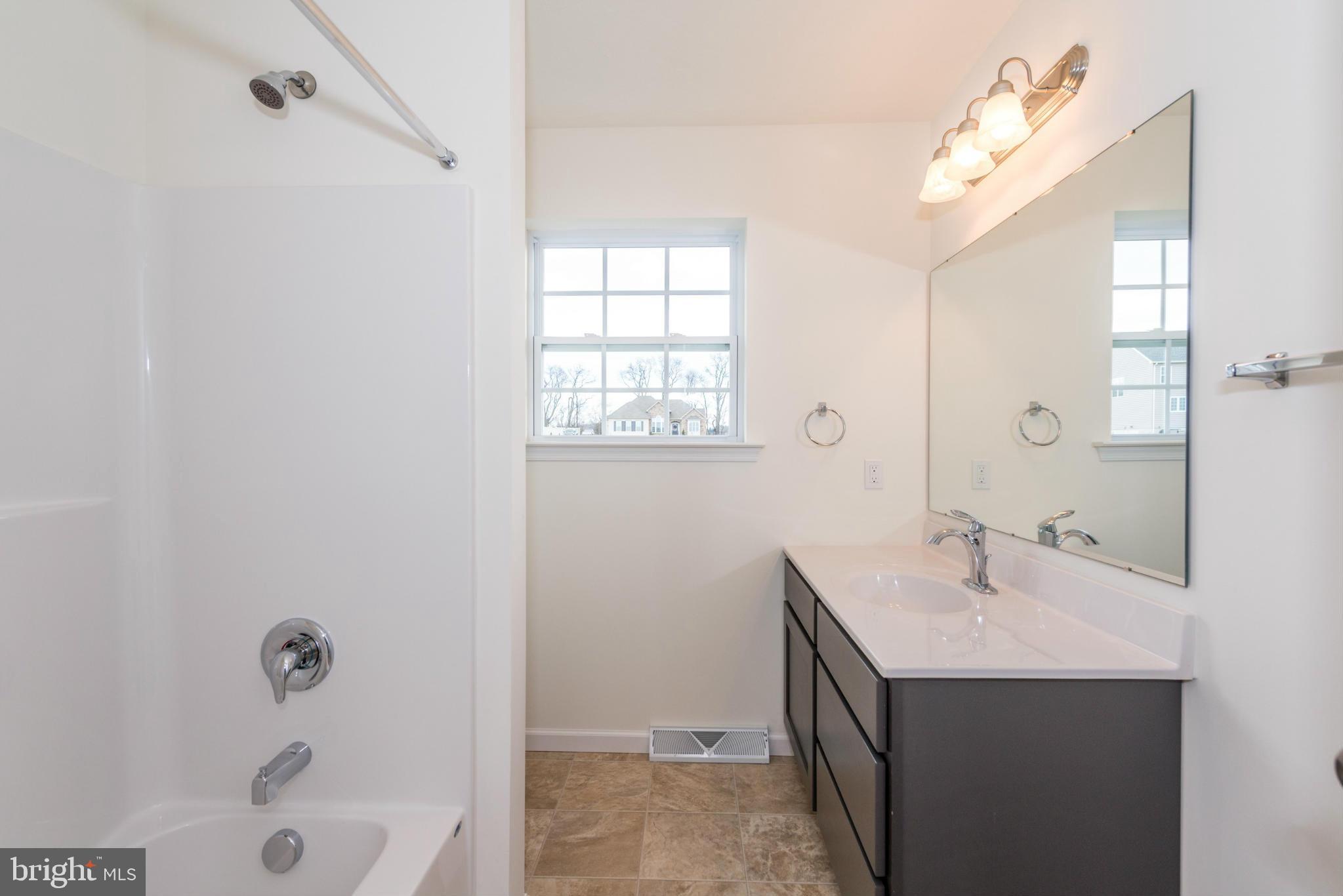 1194 Bair Road, Unit 39 Hanover, PA 17331 - Photo 8 of 12 a bathroom with a sink a vanity and shower