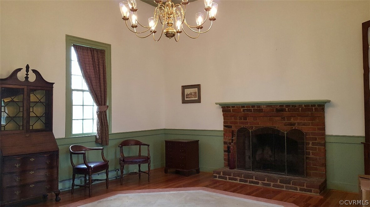 3170 Duke Road Powhatan, VA 23139 - Photo 13 of 27 Family /living room with chandelier, brick firepla
