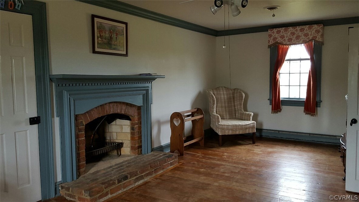 3170 Duke Road Powhatan, VA 23139 - Photo 15 of 27 Bedroom with wood floors, brick fireplace and acce