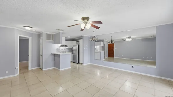 a view of a kitchen with a sink and a refrigerator