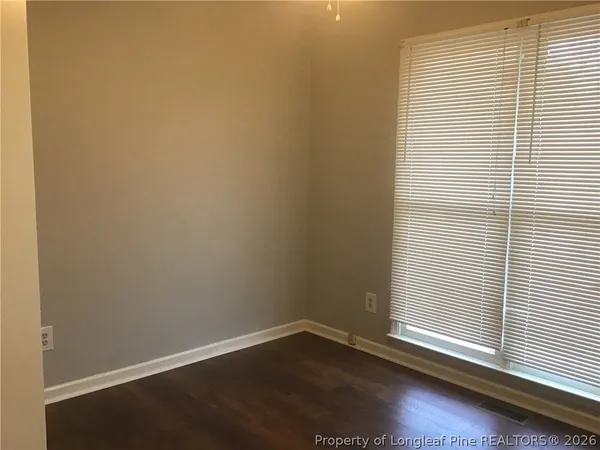 a view of a small space with wooden floor and a window