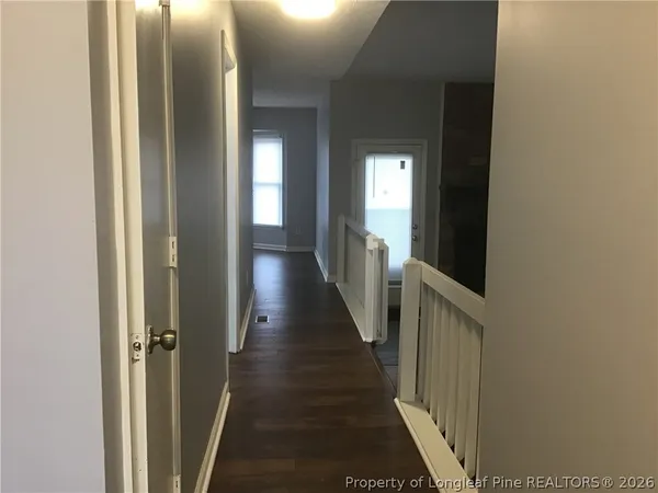 a view of a hallway with wooden floor