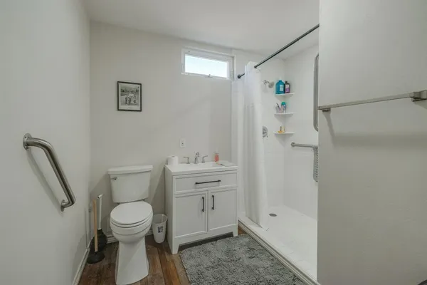 a living room with furniture and kitchen view