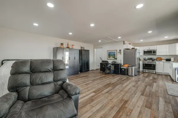 a kitchen with granite countertop a sink cabinets and stainless steel appliances