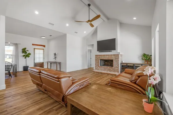 a living room with furniture fireplace and flat screen tv
