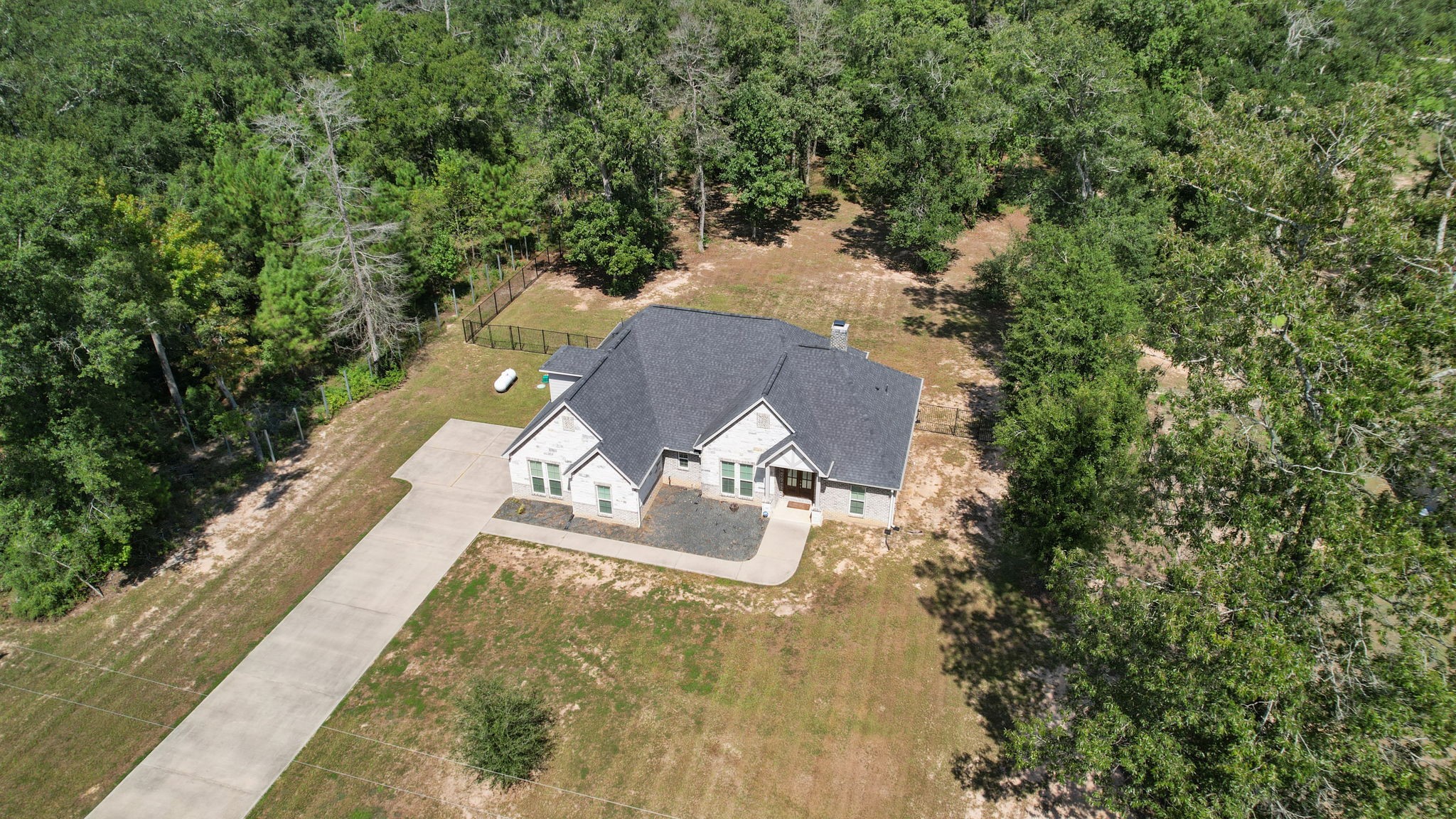 7815 Timber Switch Road Cleveland, TX 77328 - Photo 5 of 39 Nestled in a wooded setting, this charming home offers a spacious yard and a private driveway, providing a serene retreat surrounded by nature.