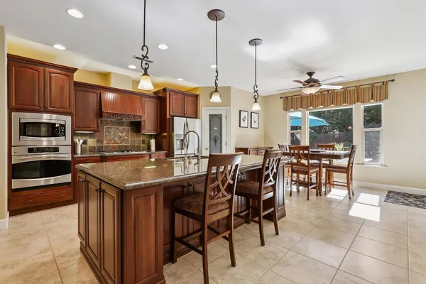 a kitchen with stainless steel appliances granite countertop a sink and cabinets