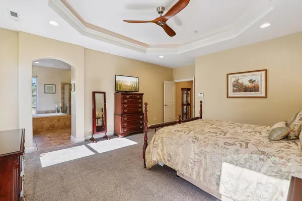 a bathroom with a granite countertop sink mirror bathtub and double