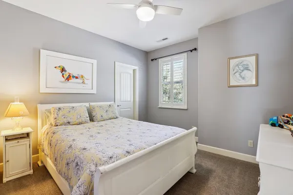 a bedroom with a bed and a painting on the wall