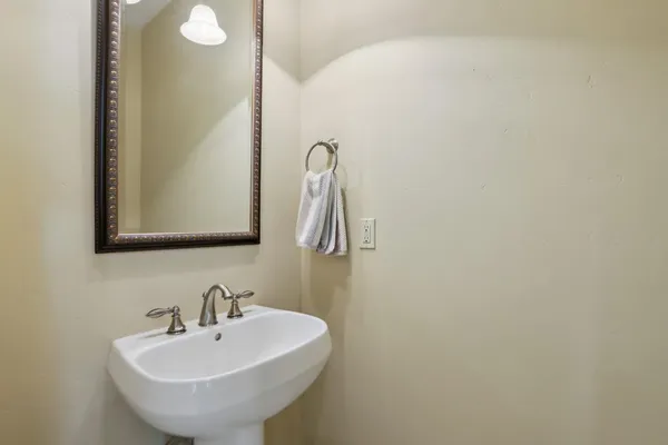 a view of pool with table and chairs under an umbrella