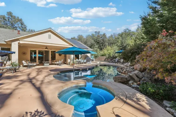 a view of a patio with a table chairs and a backyard