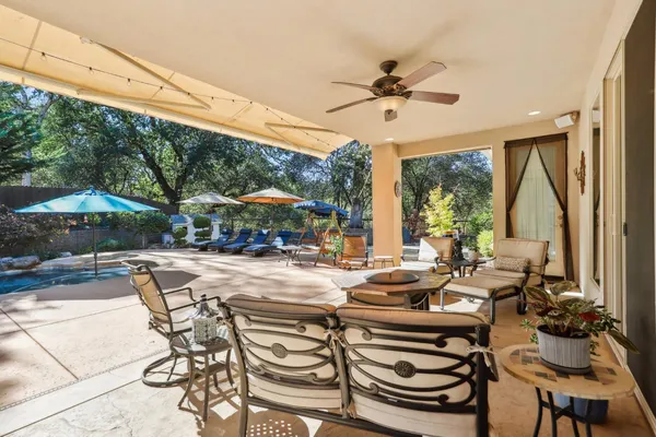 a view of backyard with outdoor seating and trees