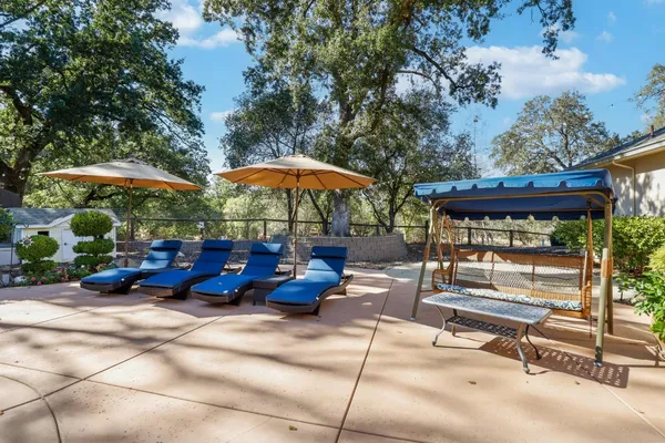 a backyard of a house with table and chairs