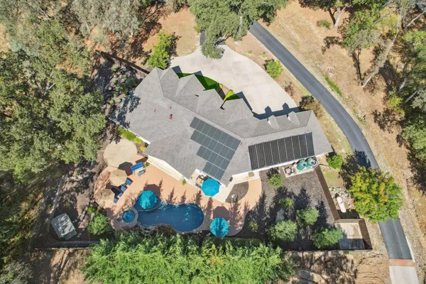 an aerial view of residential houses with city view