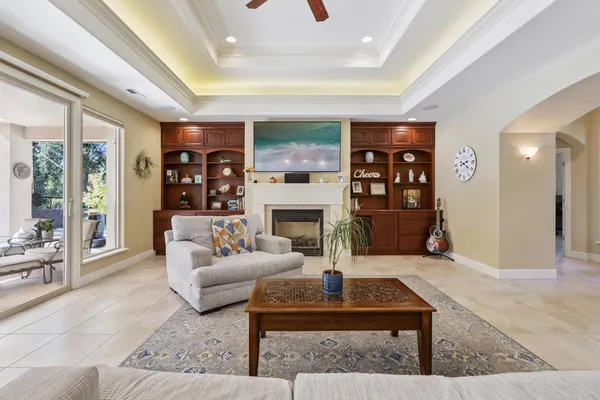 a living room with furniture large window and a fireplace