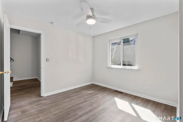 wooden floor in an empty room with a window