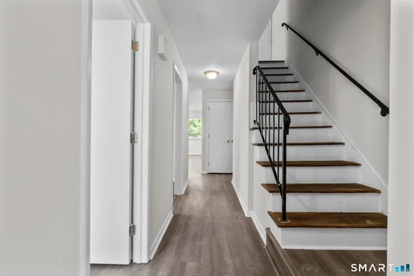a view of entryway with wooden floor and stairs