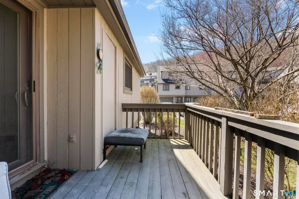 a view of balcony with wooden floor and seating space