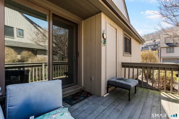 a view of balcony with furniture and wooden floor