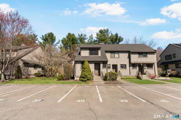 a front view of a building with a garden