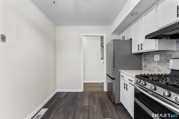 a kitchen with a stove and a refrigerator