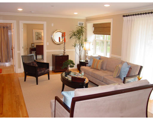 12 Russell Road, Unit 202 Wellesley, MA 02482 - Photo 4 of 15 a living room with furniture a large window and a potted plant