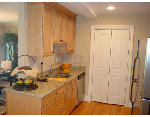 12 Russell Road, Unit 202 Wellesley, MA 02482 - Photo 6 of 15 a kitchen with stainless steel appliances granite countertop a sink a stove and a refrigerator