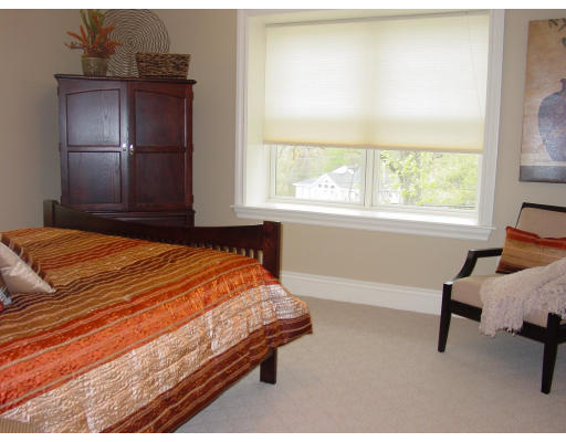 12 Russell Road, Unit 202 Wellesley, MA 02482 - Photo 8 of 15 a bed sitting in a bedroom next to a window