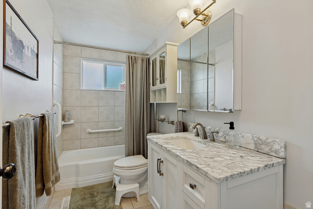 730 Geranium Street Sandy, UT 84094 - Photo 14 of 35 White vanity with a light-toned countertop and integrated sink, dual mirrored medicine cabinet, and a bathtub with tiled surround
