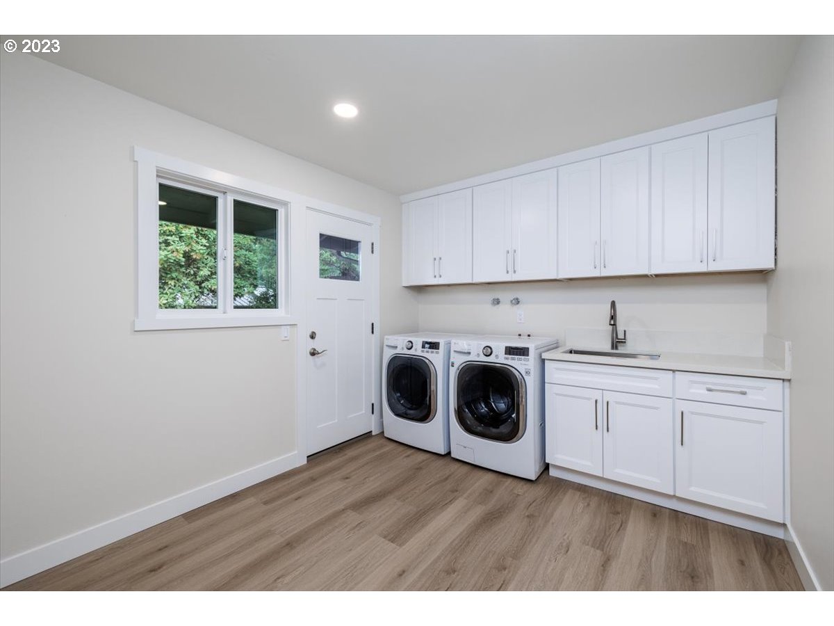 4011 Southwest 43rd Avenue Portland, OR 97221 - Photo 17 of 46 a kitchen with wooden cabinets and white appliances