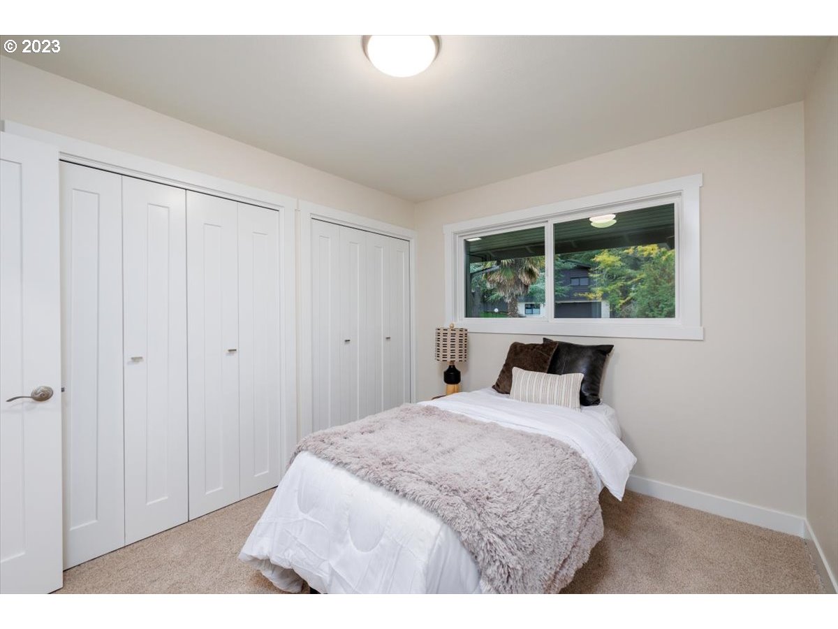 4011 Southwest 43rd Avenue Portland, OR 97221 - Photo 18 of 46 a bedroom with a bed and a window