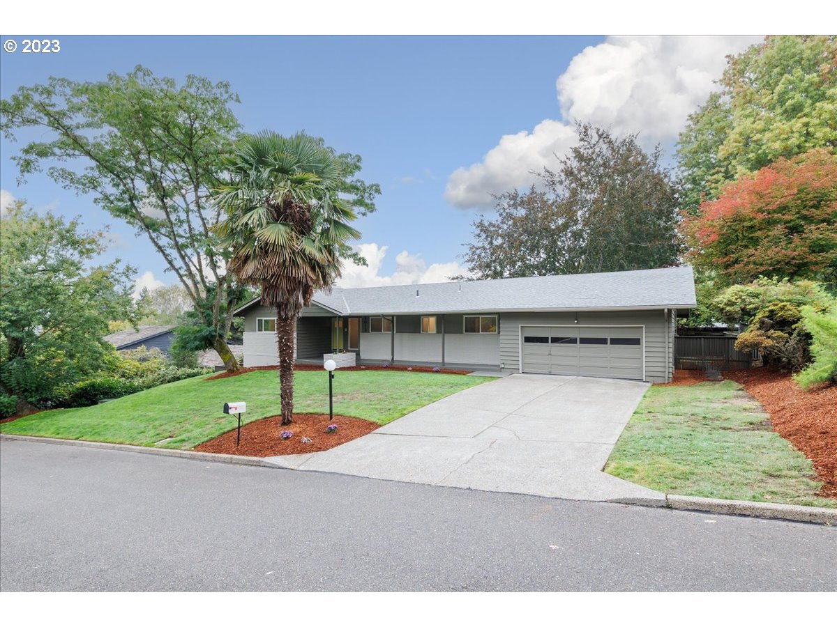 4011 Southwest 43rd Avenue Portland, OR 97221 - Photo 2 of 46 a house with trees in the background