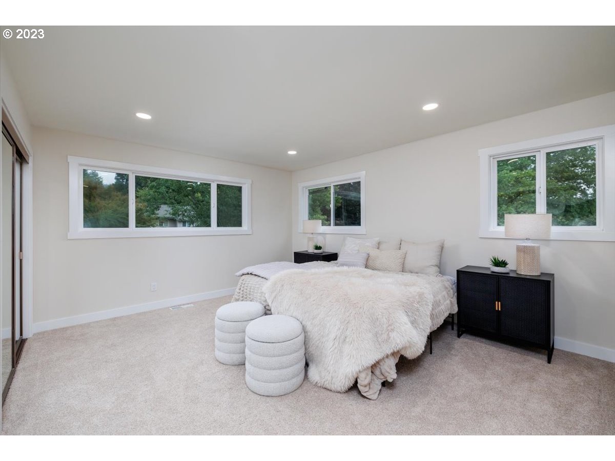 4011 Southwest 43rd Avenue Portland, OR 97221 - Photo 21 of 46 a spacious bedroom with a bed and a large window