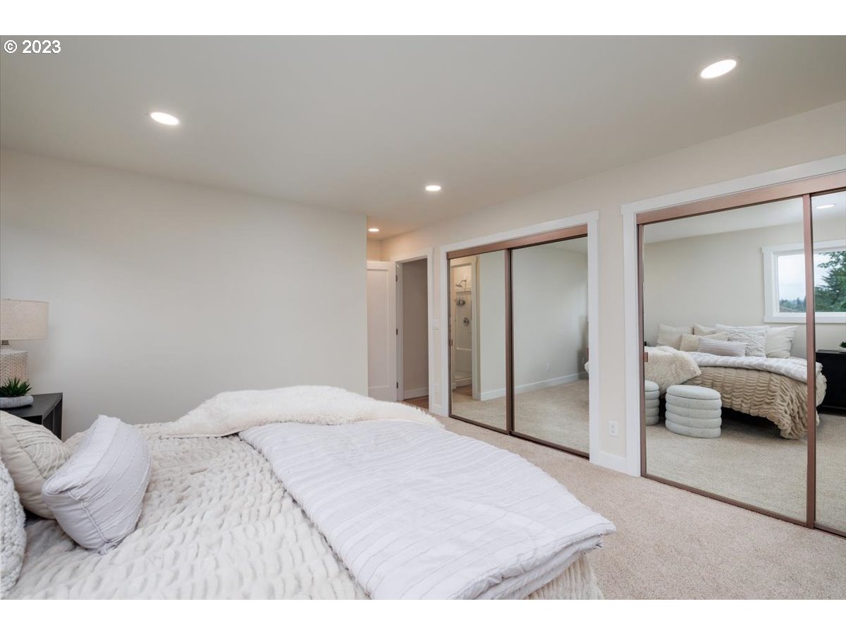 4011 Southwest 43rd Avenue Portland, OR 97221 - Photo 22 of 46 a bedroom with a bed and a large window